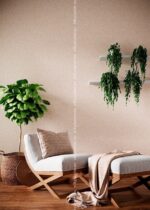Silk Plaster Relief 327 in pale blush behind a white chaise longue and hanging plants