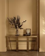 PrimeColor 5 tinted B38 warm tan entrance hall wall with a console table, dried flowers and framed art