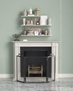 PrimeColor 5 tinted B4 sage green on a wall above a white fireplace mantel with decorative shelves