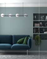 PrimeColor 5 tinted B13 teal blue-grey living room wall with a dark blue sofa and a green built-in shelf nook