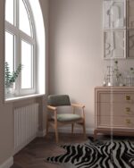 PrimeColor 5 tinted B24 dusty pink-mauve on a wall behind a pink chest of drawers, green armchair and zebra-print rug