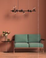 PrimeColor 5 tinted B35 terracotta living room wall with a sage green sofa and a globe pendant light