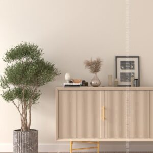 PrimeColor 5 tinted B1 pale beige on a wall behind a fluted beige sideboard with gold legs and an olive tree
