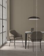 PrimeColor 5 tinted B8 warm taupe on a dining nook wall with two chairs, a pendant lamp and a laptop on the table