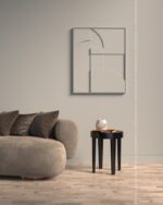 PrimeColor 5 tinted B6 warm taupe on a wall above a grey sofa with abstract line art and a round black side table