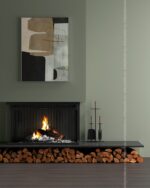 PrimeColor 5 tinted B18 sage green wall above a black fireplace with stacked firewood