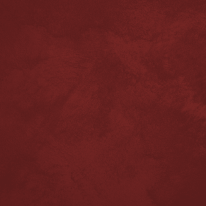 Close-up of Sabbia sand-effect paint texture in shade SA45, deep brick red