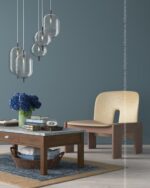 PrimeColor 5 tinted B14 blue-grey lounge wall with cluster glass pendant lights and a cream armchair