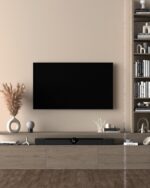 PrimeColor 5 tinted B25 warm cream living room wall with a wall-mounted TV and open bookshelf