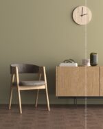PrimeColor 5 tinted B19 olive khaki wall with a wooden dining chair, wall clock and sideboard