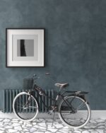 Nappa velvet-touch wall paint in deep petrol blue, framed print and a black bicycle by a radiator