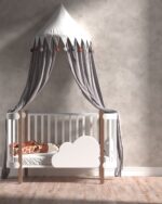 Nappa velvet-touch wall paint in soft warm grey, nursery with a white and wood cot and canopy
