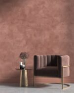 Nappa velvet-touch wall paint in terracotta rose, brown velvet armchair and brass side table