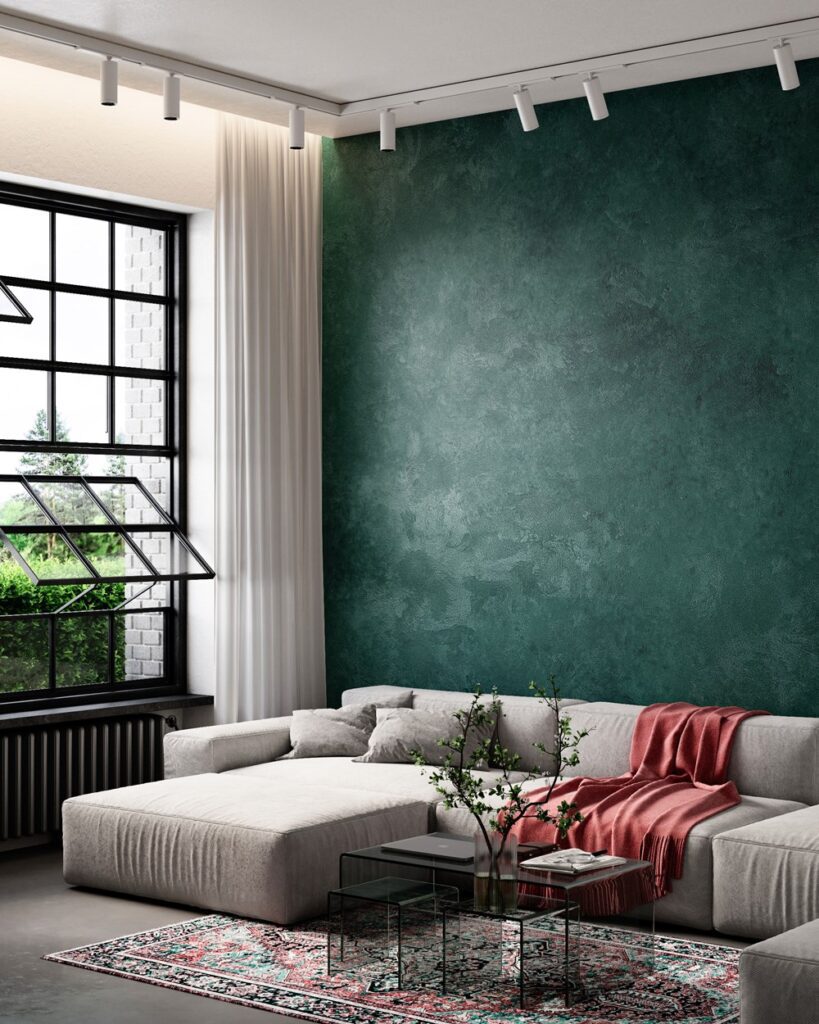 Nappa velvet-touch wall paint in deep green, living room with a beige modular sofa and red throw
