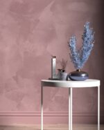 Nappa velvet-touch wall paint in dusty pink behind a white round table with dried blue branches