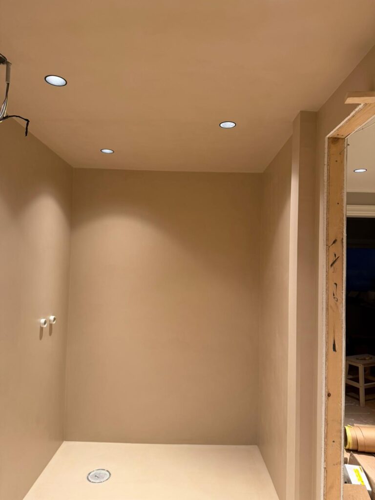 Microcement shower walls and floor during construction - seamless application Norway