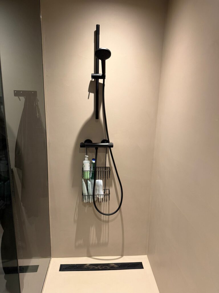 Microcement bathroom vanity detail with black fixtures - Norway project