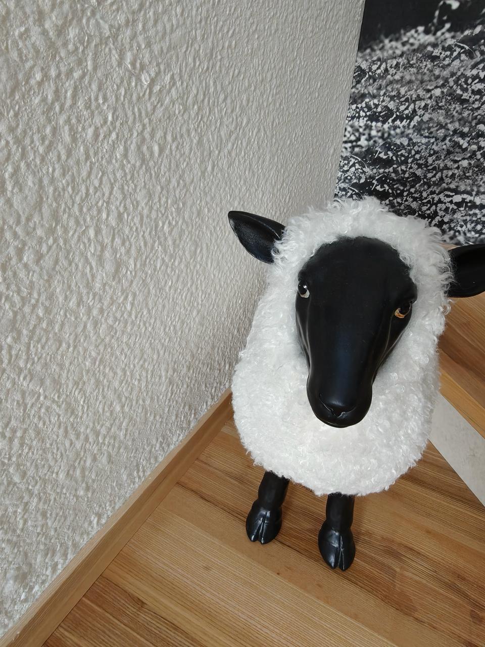 Black-face ceramic sheep figurine on a pine stair tread in front of a Tatra shepherd mural with Victoria 701 silk plaster wall