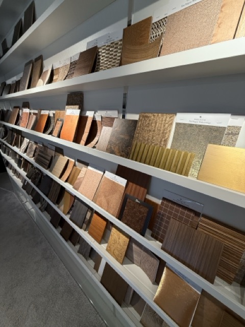 Silk Plaster seamless liquid wallpaper samples displayed on shelves at the Riga showroom