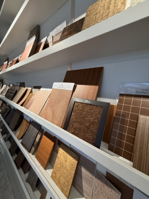 Close view of Silk Plaster liquid wallpaper and textile-fibre samples in warm tones